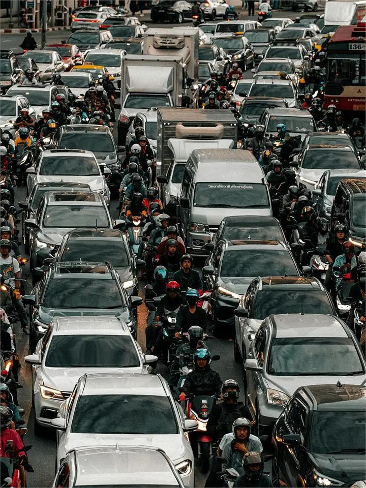 Dense city traffic of cars and motorbikes during a long commute