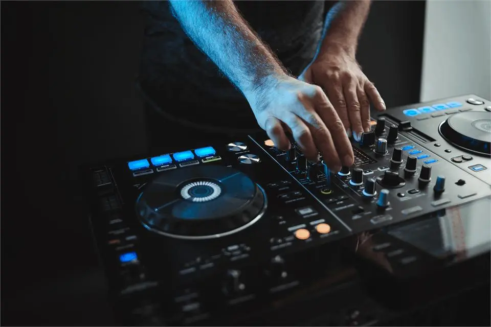 Hands of a DJ mixing music on a controller
